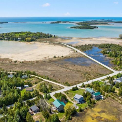Aerial view showcasing the stunning nearby shoreline and Bruce Peninsula scenery.