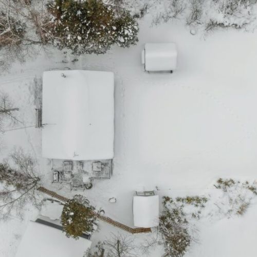 Top-down aerial view showing the cottage layout, private yard, and bonus insulated bunkie.