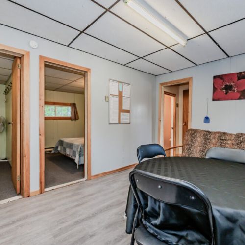 The dining area opens to the kitchen, with two cozy bedrooms accessible for comfortable accommodation.