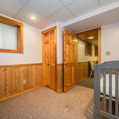 A crib for infants and closet space for changing bag or kids clothes.