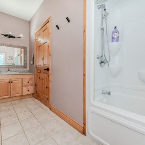 Modern bathroom with full tub and soft lighting—refresh after a day of hiking, exploring, or lounging by the water