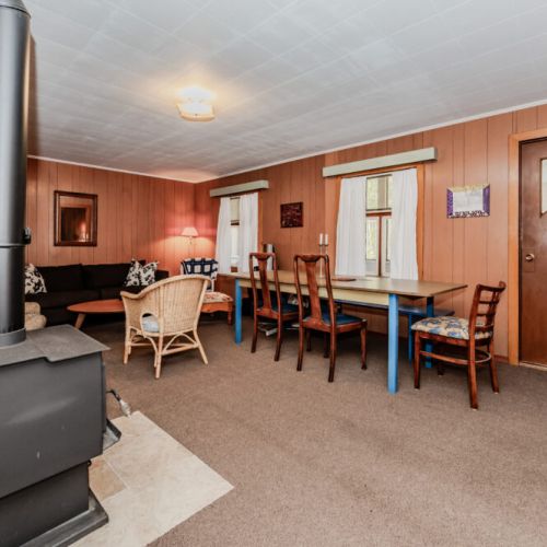 Charming open living and dining space with warm cottage vibes—great for family dinners, game nights, and cozy evenings at your vacation retreat.