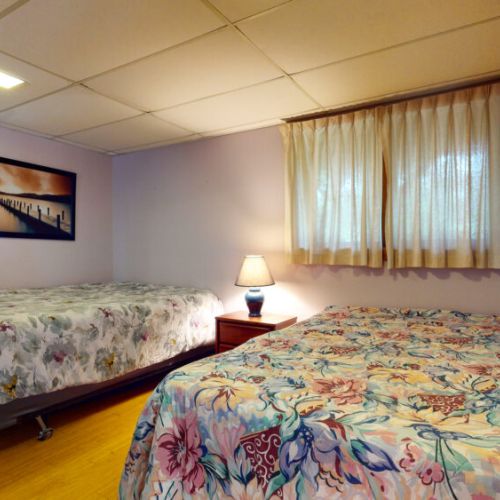 The lower level bedroom with two double beds.