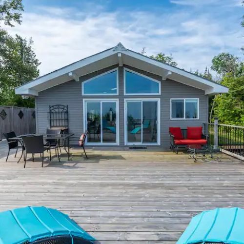 The back of Sunset Cove opens onto a sprawling deck where you’ll find plenty of seating to lounge, dine, and soak up the sun. From here, you can watch the sky change colors at sunset and enjoy unforgettable evenings under the stars.
