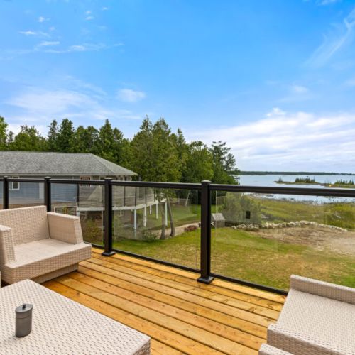 Unwind on the outdoor lounge furniture while soaking in the tranquil waterfront scenery.