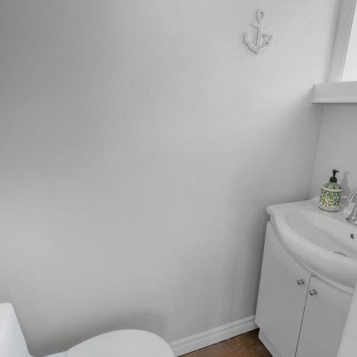 A clean, functional bathroom with modern vanity and bright finishes. Designed for comfort and convenience during your coastal cottage vacation.
