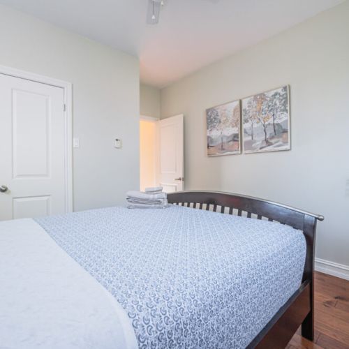 Relax in this inviting bedroom with double windows and modern comfort—great for small groups or families on a cottage escape.