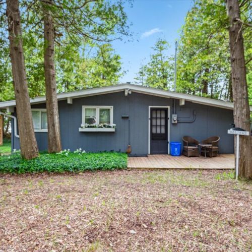Step inside the cozy front entrance of Summer Side, complete with a deck for morning coffee or relaxed evening chats beneath the trees.