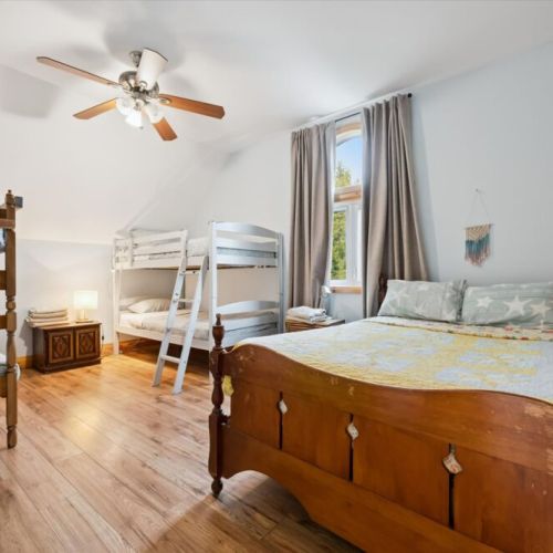 Bedroom 2: This cozy bedroom offers comfortable sleeping space with natural light and peaceful cottage charm.