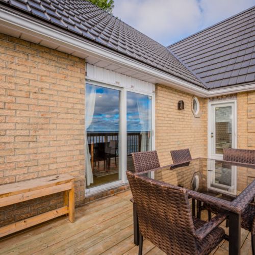 The deck provides a cozy spot for outdoor dining, perfect for relaxing with a cup of coffee or hosting a barbecue.