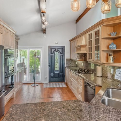 A welcoming kitchen and entry with natural light and quality finishes. Designed for seamless arrivals and comfortable vacation living.