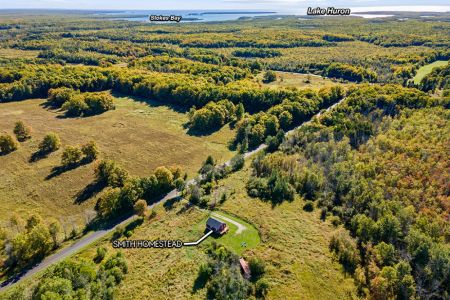 From above, see just how close Smith Homestead is to the natural beauty of Ira Lake, with Lake Huron and Stokes Bay in the distance.