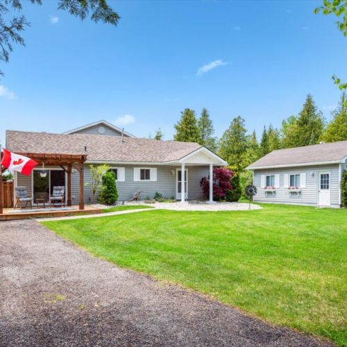 Welcome to Heaven on Earth — your peaceful lakeside retreat with ample parking, a cozy front porch, and charming landscaped surroundings.