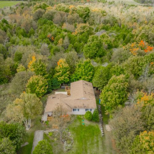 A stunning aerial view of the property nestled in lush greenery, offering a serene escape surrounded by nature.