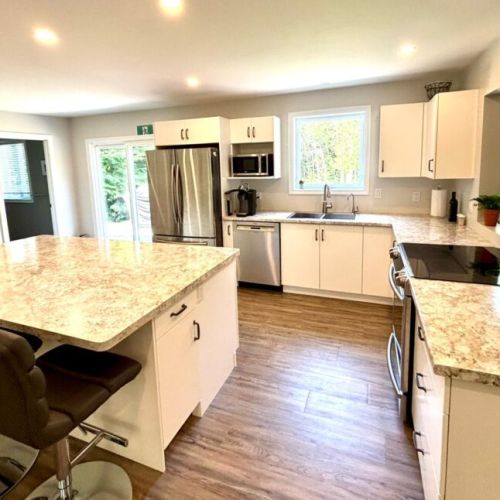 Gather around the spacious island in this bright, open-concept kitchen—perfect for morning coffee or evening laughs.