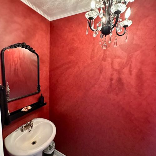 Charming half bath featuring an antique chandelier and cottage character.