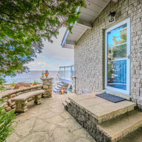"The side entry offers easy access to the stunning outdoor spaces and breathtaking water views. Perfect for transitioning from a day by the bay to the comfort of this multi-generational retreat.