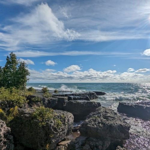 Bask in the beauty of sunlit shores and turquoise surf—perfect for nature lovers seeking a peaceful moment by the water’s edge.