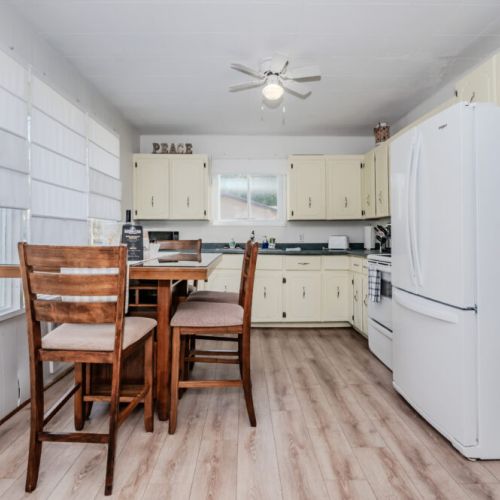 Fully equipped kitchen with vintage charm, modern appliances, and a high-top dining table—perfect for cooking and sharing family meals.