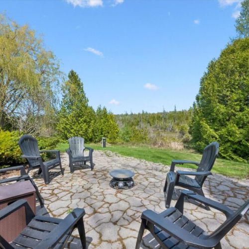 Beautiful stone patio with fire pit seating ideal for evening gatherings under the stars.