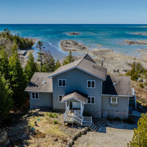 Escape to a secluded lakefront home with panoramic views and direct access to pristine Georgian Bay shoreline.