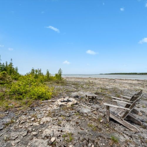 Just steps away from the cottage, gather around the firepit on the rocky lakeshore — enjoy starry skies, storytelling, and unforgettable lakeside moments.