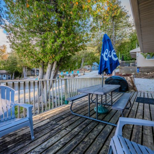 A comfortable seating area on the deck with Adirondack chairs, ideal for soaking in the surrounding nature.