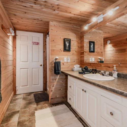 The cabin-style bathroom blends rustic charm with modern amenities, ensuring every moment of your stay is as comfortable as it is memorable.