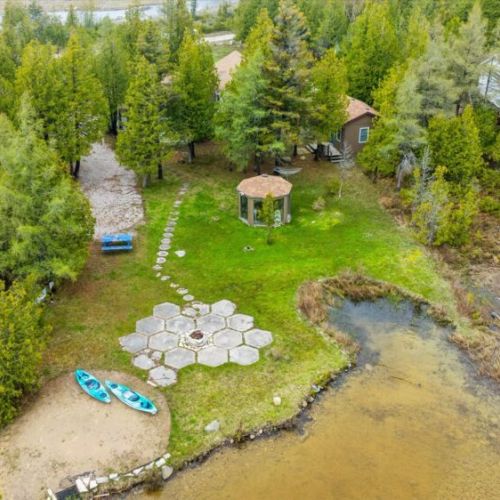 Enjoy your own slice of paradise with a sandy beach, lakeside firepit, gazebo, and plenty of outdoor space for family fun.