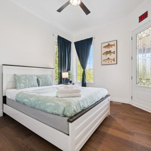 Bedroom 4: Bright bedroom with queen bed and convenient access to the outdoors