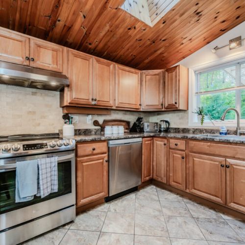 Gather around in the living room to watch a movie or enjoy some downtime in this inviting space with comfortable seating and beautiful wood accents.