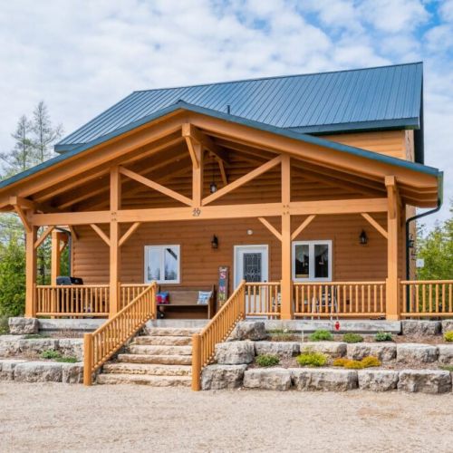 A massive Southern-style porch greets you as you arrive, wrapping around the side of the cottage and overlooking the yard.