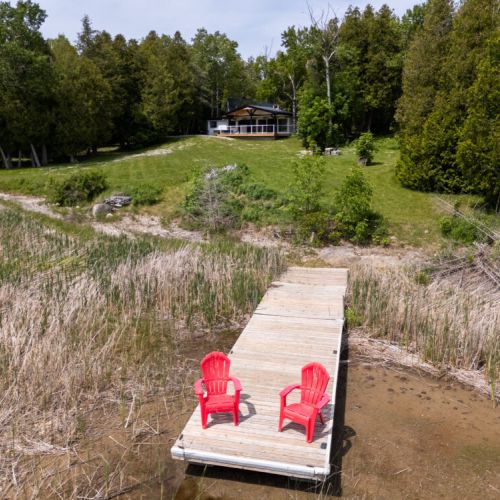 Your private dock with the iconic red chairs and a beautiful view back to the cottage.