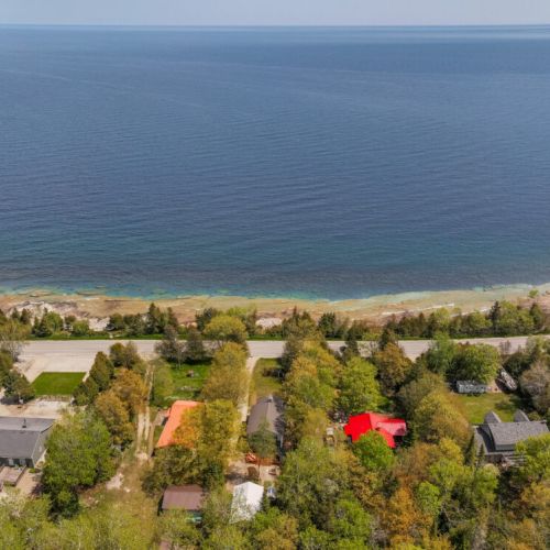 An expansive aerial view of the coastline and the properties along the shore.