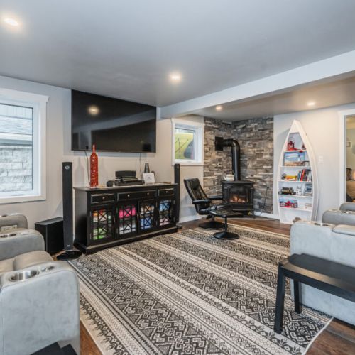 Warm and inviting living space featuring a wood stove and plenty of room to gather.