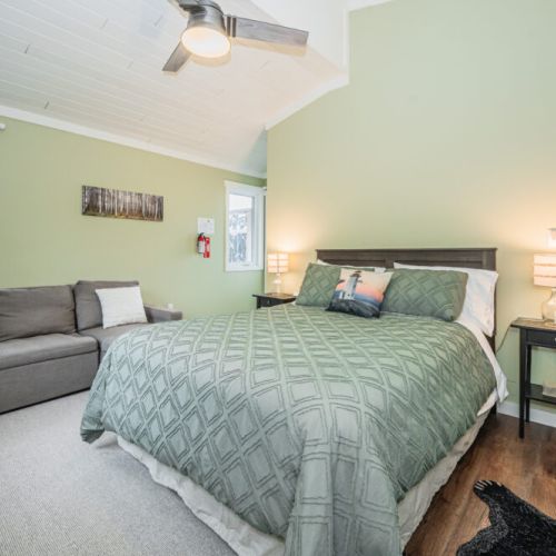 Bedroom 2: Bright and cozy bedroom with a plush bed and comfortable seating area.