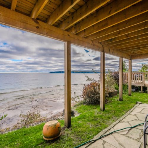 Relax on the private waterfront deck with stunning, uninterrupted views of the crystal-clear waters of Georgian Bay, perfect for soaking in the beauty of nature.