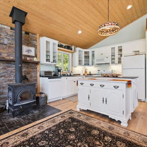 The bright, fully equipped kitchen is the heart of the cottage, blending modern convenience with warm cottage charm.