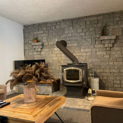 Featuring a cozy fireplace and smart TV, the lower lounge area is perfect for entertaining.