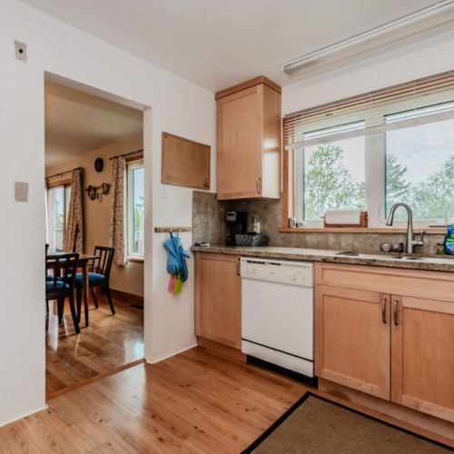 Fully equipped kitchen with natural light and everything you need to prepare meals during your stay. Easy flow into the dining area for convenience.