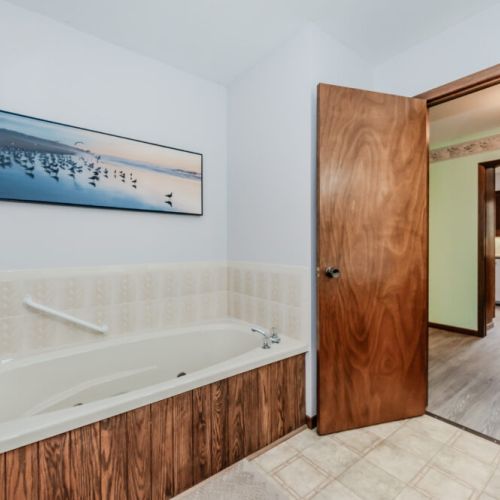 Relaxing bathroom with a luxurious soaker tub – the perfect spot to unwind after a day on the beach.