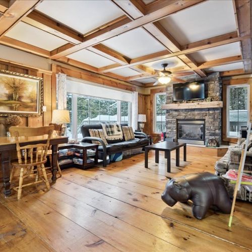 Cozy living area filled with natural light, ideal for relaxing by the fire after a day at the lake.