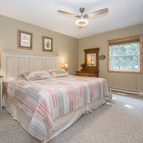 Another gorgeous bedroom with cozy linens and ceiling fan to keep the heat down.