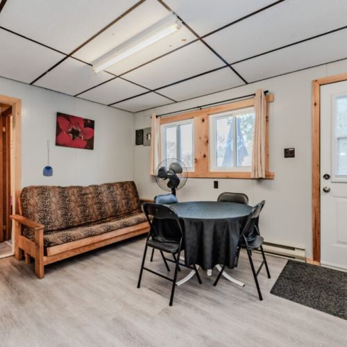 An inviting space with a futon, table, and chairs, perfect for gathering and relaxation.