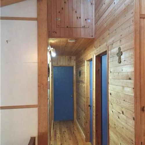 Charming wood-lined hallway adding to the cottage’s warm, rustic character.