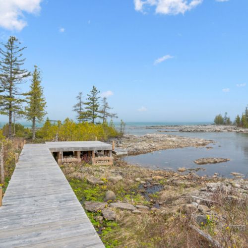 Private boardwalk leading to the shoreline, perfect for exploring the natural waterfront landscape.