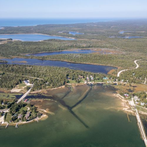 Sweeping aerial of Stokes Bay highlighting the calm waters and surrounding natural beauty.