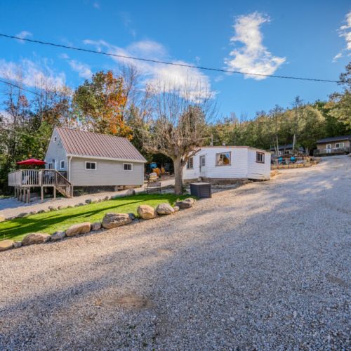 View of the cabin grounds, showcasing the variety of cottages available and the welcoming atmosphere with outdoor space to unwind.