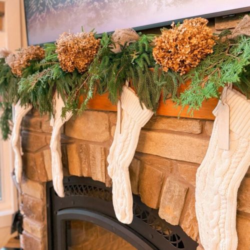 Holiday coziness at its finest—crackling fire, festive greens, and warm winter charm.