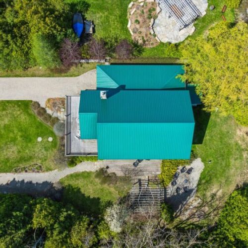 Overhead aerial view highlighting the cottage layout and spacious property setting.